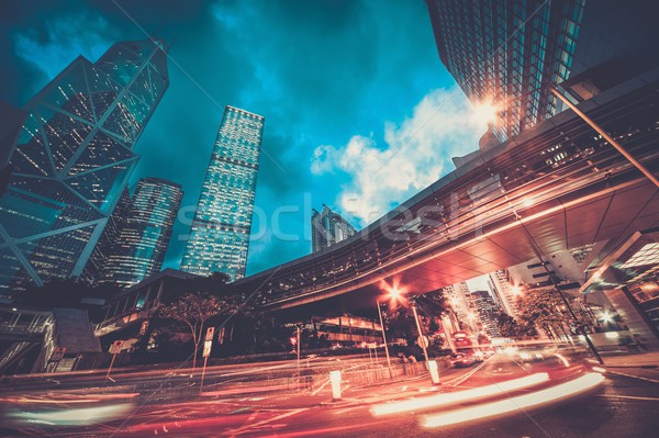 Fast moving cars at night in modern city Stock photo © Nejron