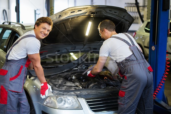 Two mechanics fixing car in a workshop Stock photo © Nejron