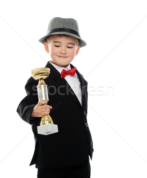 Happy boy in black suit holding prize cup Stock photo © Nejron