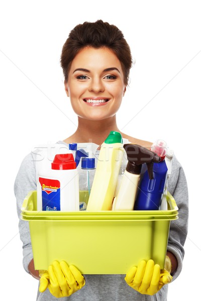 Stock photo: Beautiful cheerful brunette woman in gloves holding different cleaning stuff 