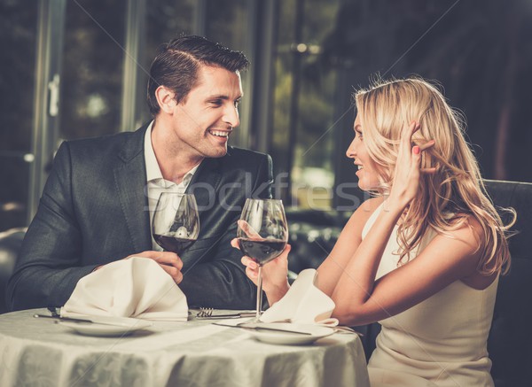 Cheerful couple in a restaurant with glasses of red wine Stock photo © Nejron