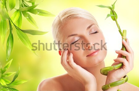 Beautiful woman with green plant Stock photo © Nejron