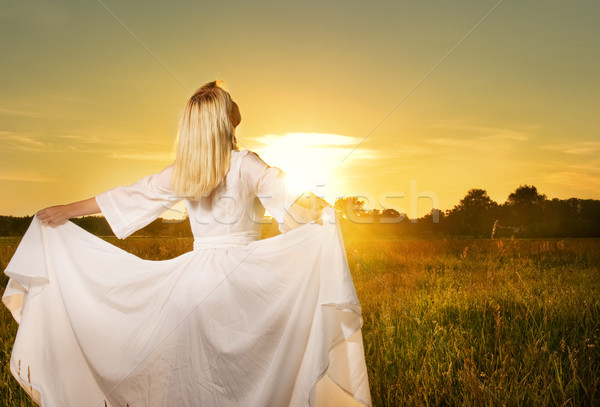 Beautiful woman with in the field at sunset Stock photo © Nejron
