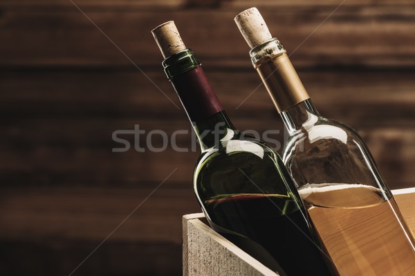 Bottle of red and white wine in wooden box Stock photo © Nejron