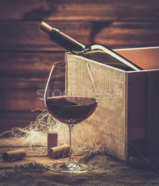 Bottle and glass of red wine on a wooden table  Stock photo © Nejron