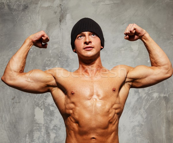 Handsome man with muscular torso in beanie hat posing  Stock photo © Nejron