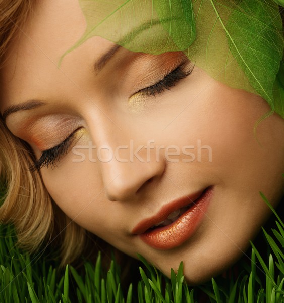 Dreaming young woman lying on a fresh spring grass  Stock photo © Nejron