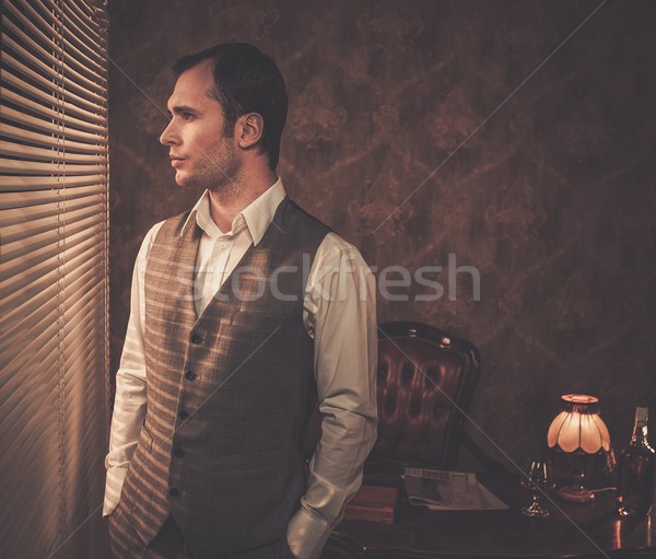 Well-dressed man looking through jalousie Stock photo © Nejron