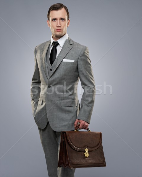 Сток-фото: бизнесмен · портфель · изолированный · серый · деньги · моде