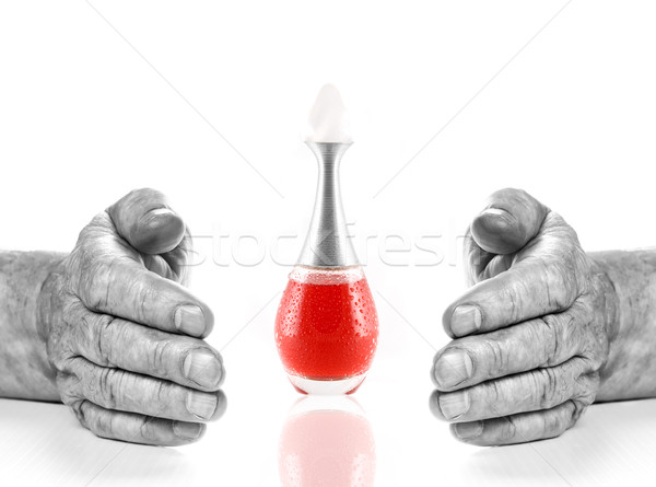 Monochrome hands of old man and bottle with red liquid between t Stock photo © Nejron