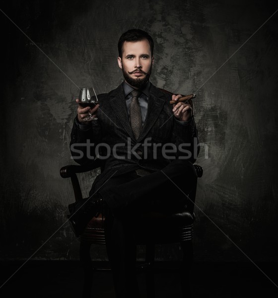 Handsome well-dressed with glass of beverage and cigar Stock photo © Nejron