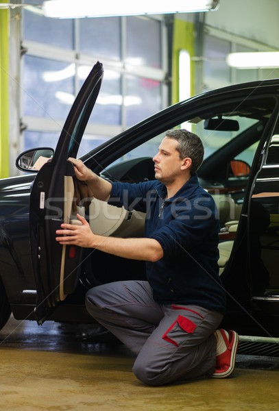 Worker on a car wash cleaning car interior  Stock photo © Nejron