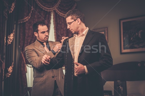 Tailor measuring client for custom made suit tailoring  Stock photo © Nejron