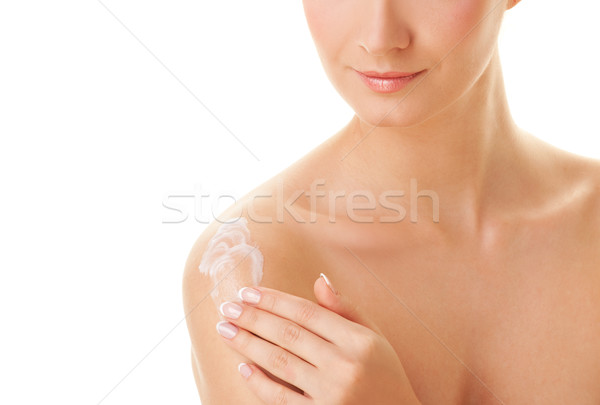 Young beautiful woman applying moisturizer to her skin after sho Stock photo © Nejron
