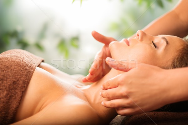 Beautiful young woman having massage in a spa salon Stock photo © Nejron