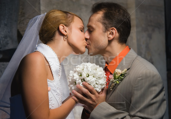Just married couple kissing holding a round bouquet of white flo Stock photo © Nejron