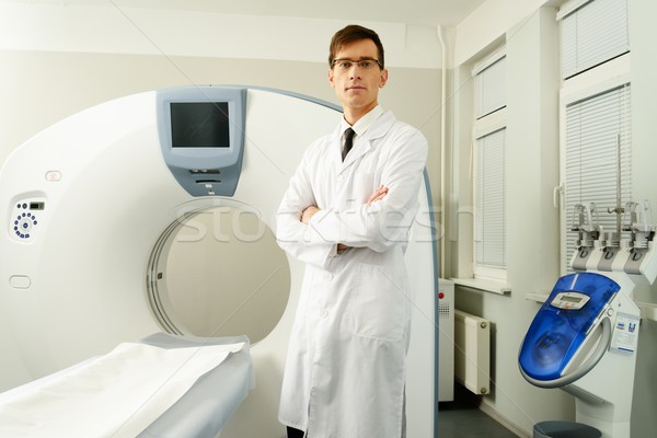 Young doctor standing near computed tomography scanner in a hospital Stock photo © Nejron