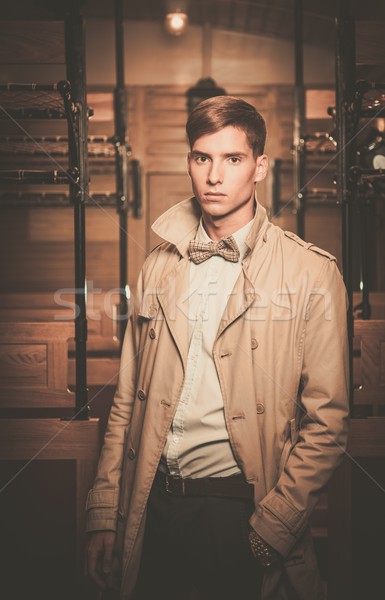 Handsome young man in coat inside vintage train coach  Stock photo © Nejron