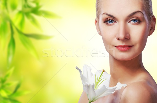 Beautiful young woman with lily flower on abstract background Stock photo © Nejron