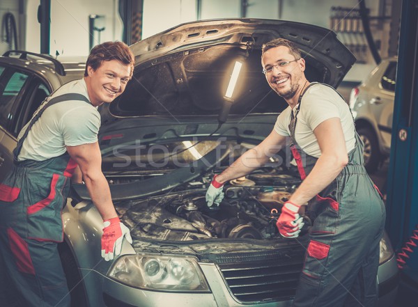 Two mechanics fixing car in a workshop Stock photo © Nejron