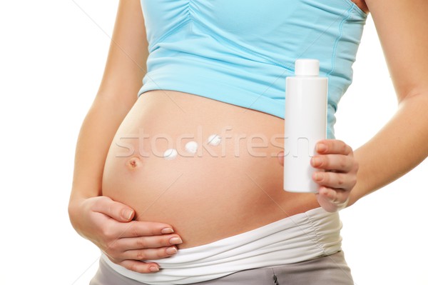 Terhes nő jelentkezik krém has nő baba Stock fotó © Nejron