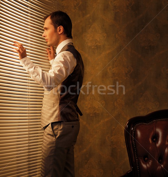 Man looking through jalousie Stock photo © Nejron