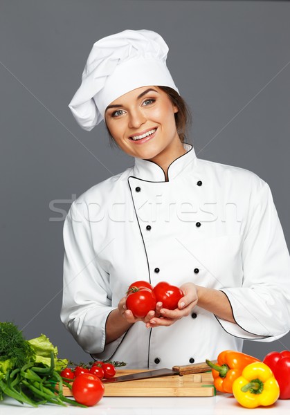 Beautiful young woman cook with fresh tomatoes  Stock photo © Nejron