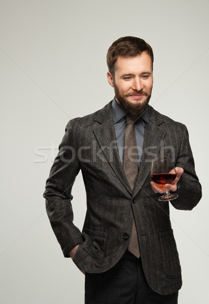 Handsome well-dressed man in jacket with glass of beverage Stock photo © Nejron