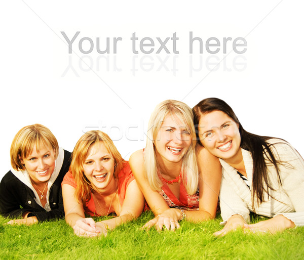 Group of happy friends lying on a green grass Stock photo © Nejron