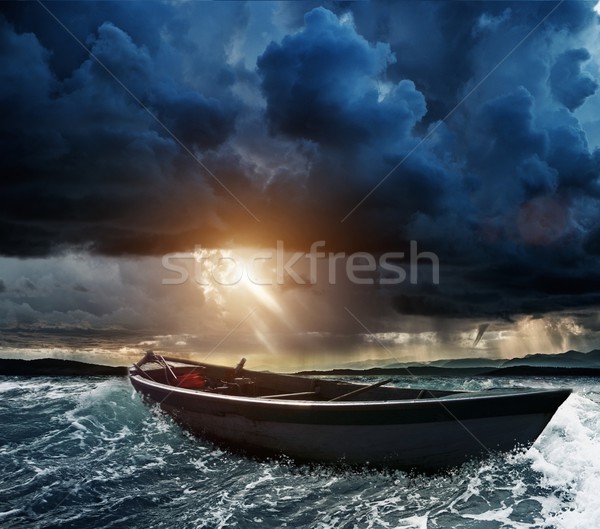 Wooden boat in a stormy sea  Stock photo © Nejron
