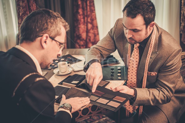 Tailor and client choosing cloth and buttons for custom made suit  Stock photo © Nejron