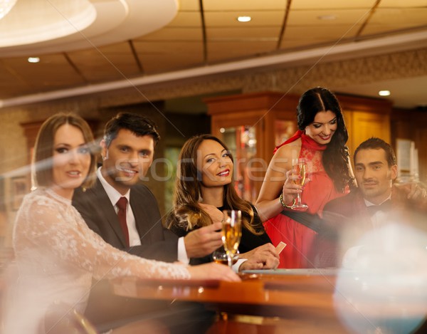 Group of young people playing poker in a casino Stock photo © Nejron