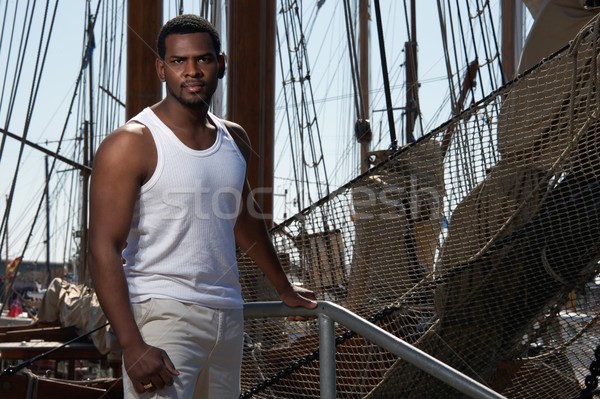 Handsome afro-american sailor against boats. Stock photo © Nejron