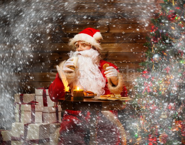 Santa Claus  in wooden home interior with glass of milk and oatmeal cookies Stock photo © Nejron