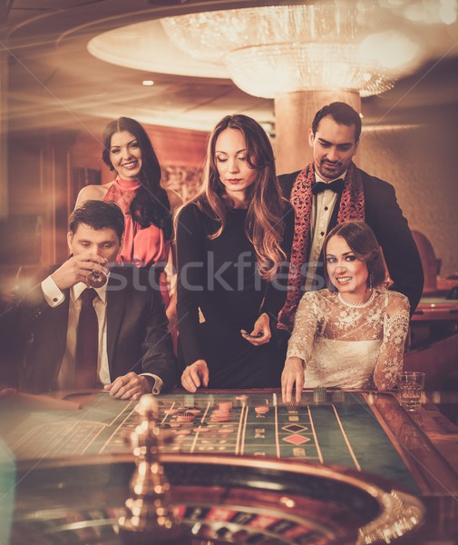 Group of stylish people playing in a casino Stock photo © Nejron