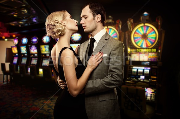 Retro couple against slot machines Stock photo © Nejron