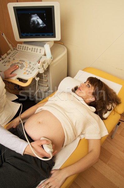 Young pregnant woman on ultrasound examination at hospital Stock photo © Nejron