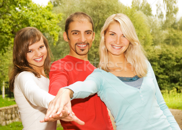 Group of young people put hands on top of each other Stock photo © Nejron