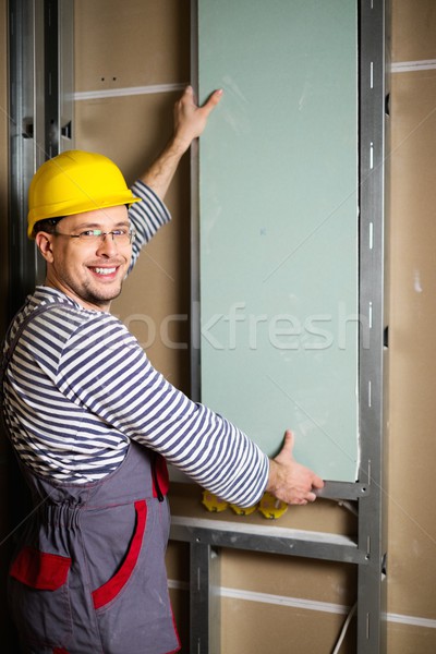 Builder with plasterboard in new building interior  Stock photo © Nejron
