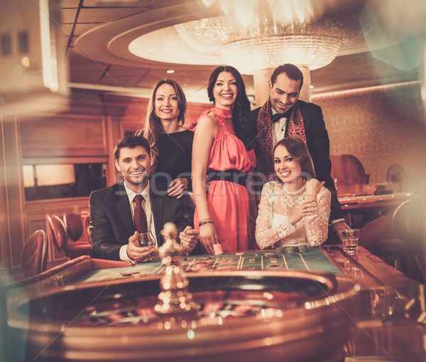 Group of stylish people playing in a casino Stock photo © Nejron