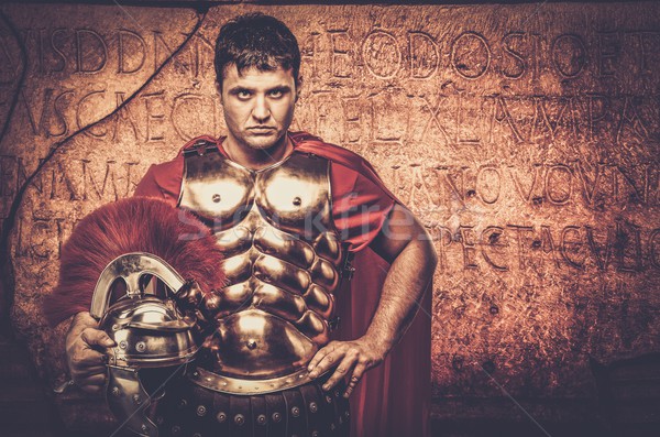 Roman legionary soldier in front of  wall with ancient writing  Stock photo © Nejron