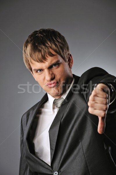 Businessman showing his thumb down  Stock photo © Nejron