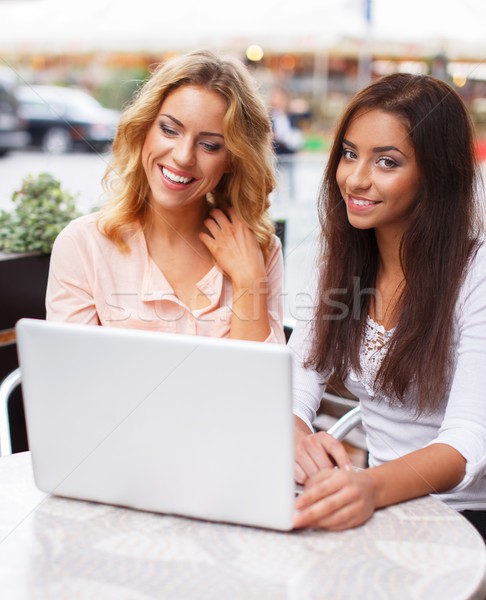 Two beautiful girls with laptop in summer cafe  Stock photo © Nejron