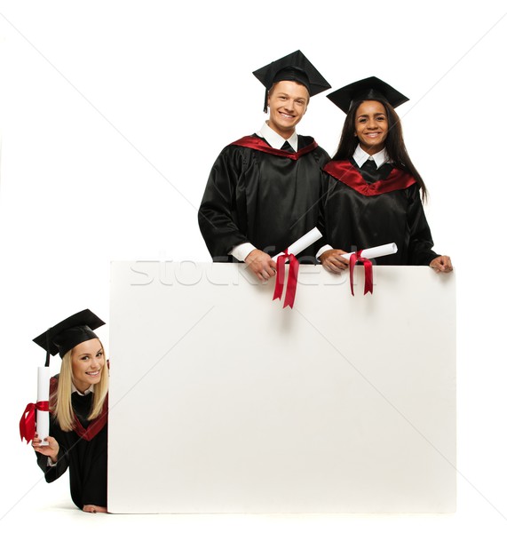 Multi ethnic group of graduated young students with blank notice board Stock photo © Nejron