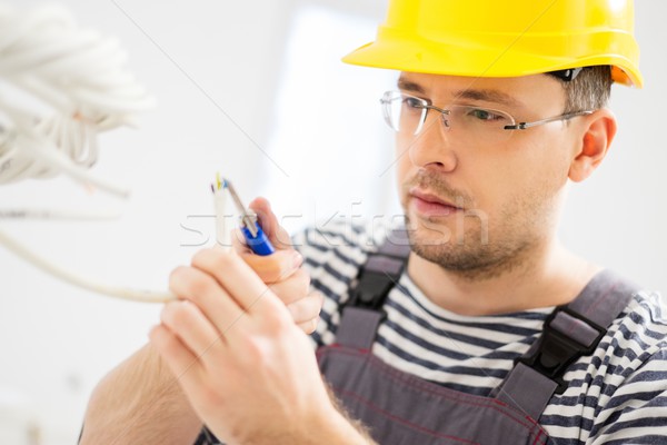 Electrician working with wires in new apartment  Stock photo © Nejron