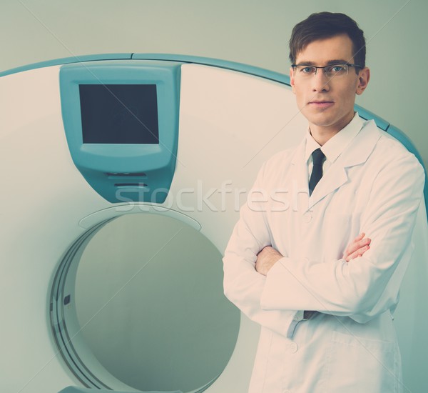 Young doctor standing near computed tomography scanner in a hospital Stock photo © Nejron