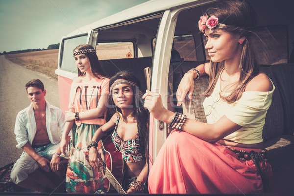 Multi-ethnic hippie friends with guitar on a road trip Stock photo © Nejron