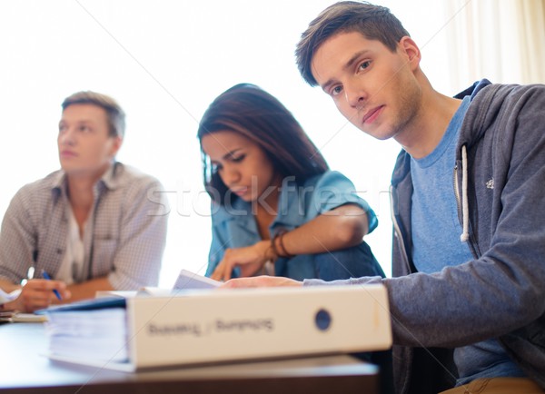 Multi ethnic group of students preparing for exams in home interior behind table  Stock photo © Nejron