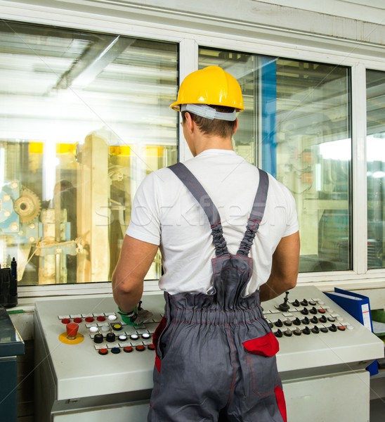 Operator wearing safety hat in a factory control room Stock photo © Nejron