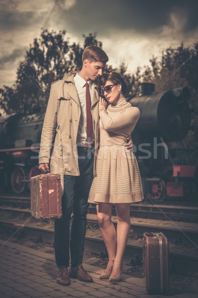 Beautiful vintage style couple with suitcases on  train station platform Stock photo © Nejron